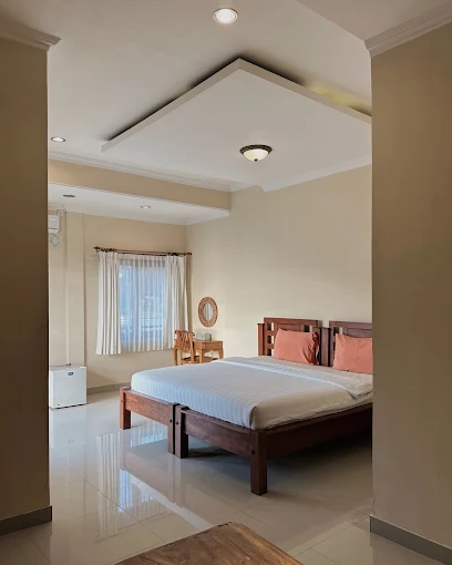 Guest room with a double bed and bright tiled floor at Divers Cafe Amed